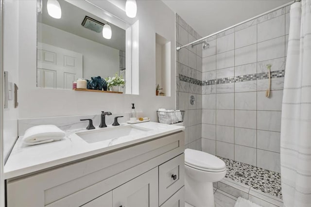 bathroom featuring vanity, toilet, and curtained shower