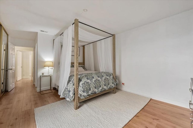 bedroom with wood-type flooring