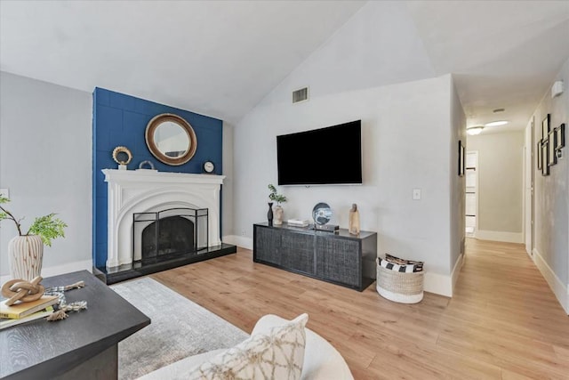 living room with lofted ceiling and hardwood / wood-style floors