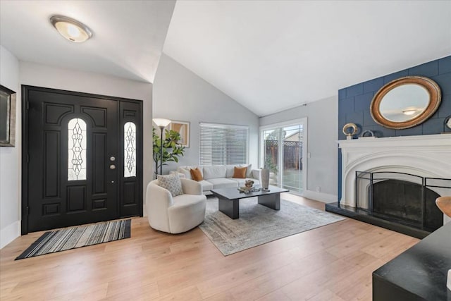 entrance foyer with high vaulted ceiling and light wood-type flooring