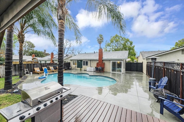 view of swimming pool featuring area for grilling and a patio area