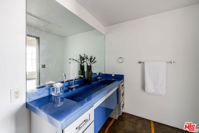 bathroom with vanity and concrete floors