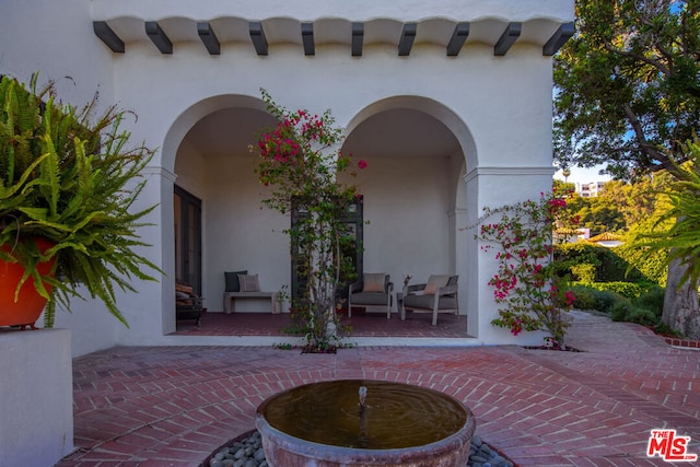 property entrance featuring a patio area