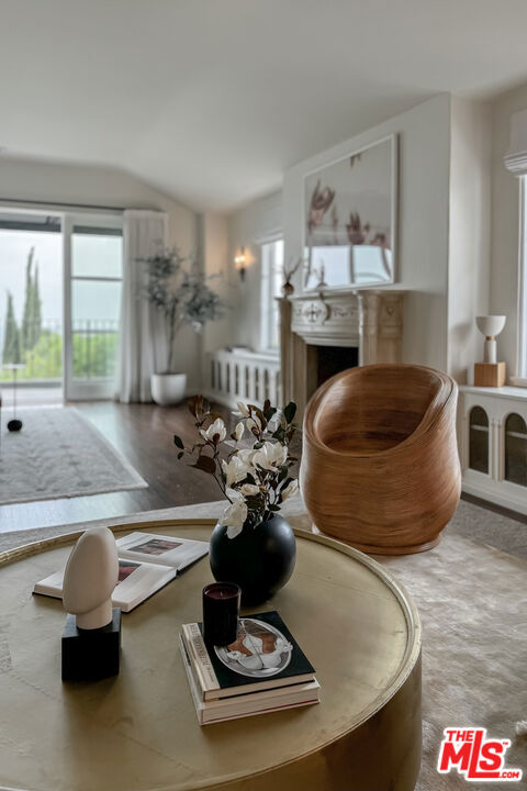 dining space with vaulted ceiling and radiator