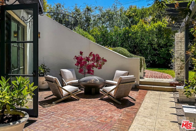 view of patio / terrace featuring an outdoor fire pit