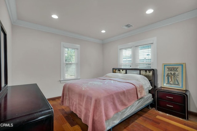 bedroom featuring multiple windows, crown molding, and hardwood / wood-style flooring