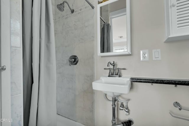 bathroom with shower / bath combo and sink