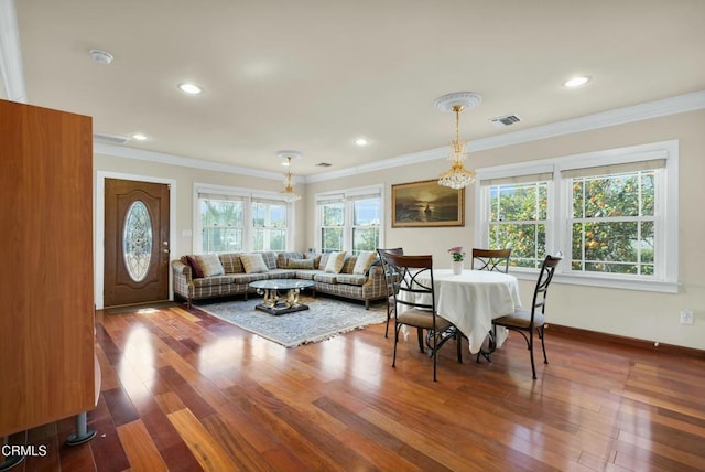 dining area featuring ornamental molding and hardwood / wood-style floors