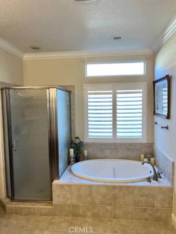 bathroom featuring tile patterned flooring, crown molding, plus walk in shower, and a textured ceiling