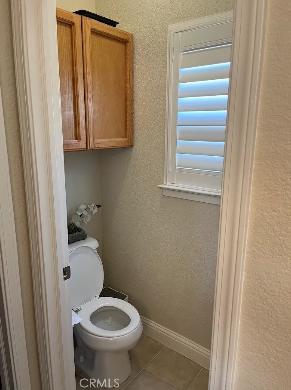 bathroom with tile patterned flooring and toilet