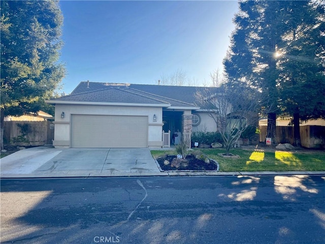 ranch-style home with a garage and a front yard