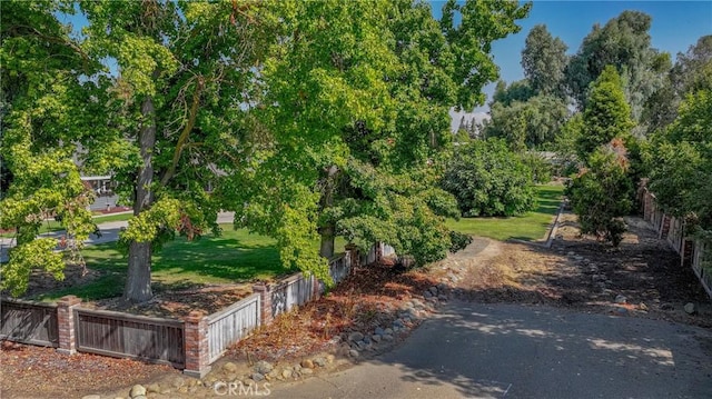 surrounding community with a yard and fence