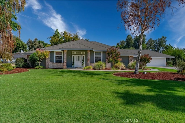 ranch-style home featuring a front yard, brick siding, and a garage