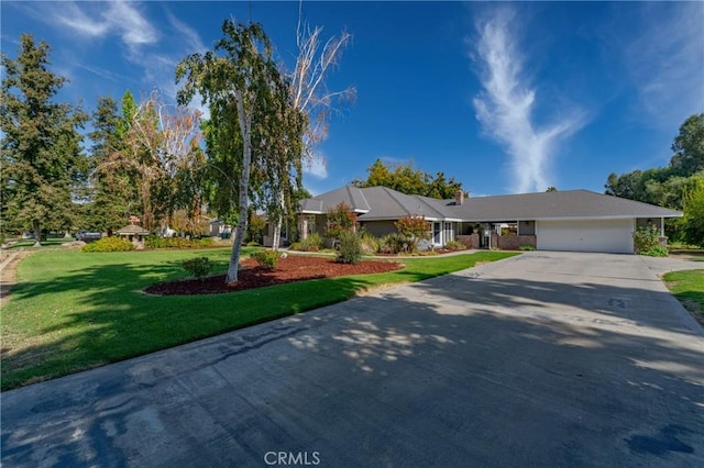 ranch-style home featuring a garage and a front lawn