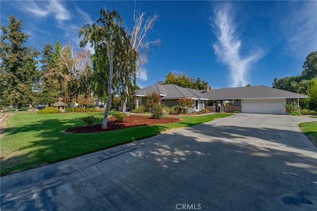 single story home featuring a front lawn, a garage, and concrete driveway