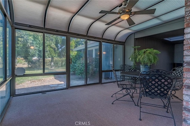 sunroom / solarium with plenty of natural light, outdoor dining area, and a ceiling fan
