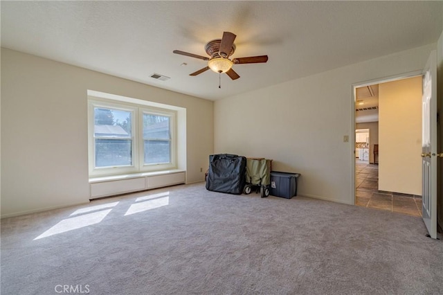 interior space featuring ceiling fan and carpet floors