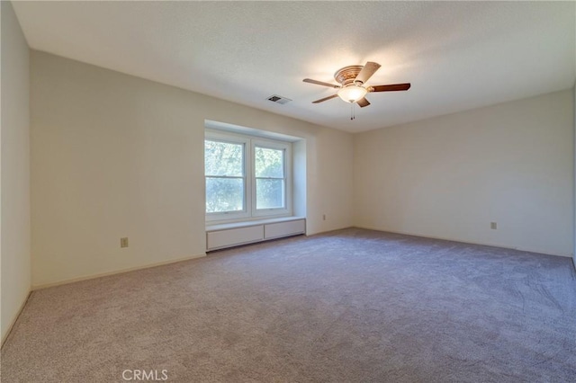 spare room with carpet floors and ceiling fan