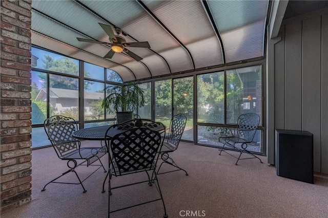 unfurnished sunroom featuring ceiling fan