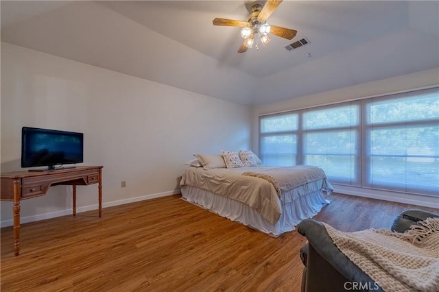 bedroom featuring hardwood / wood-style flooring, lofted ceiling, and ceiling fan