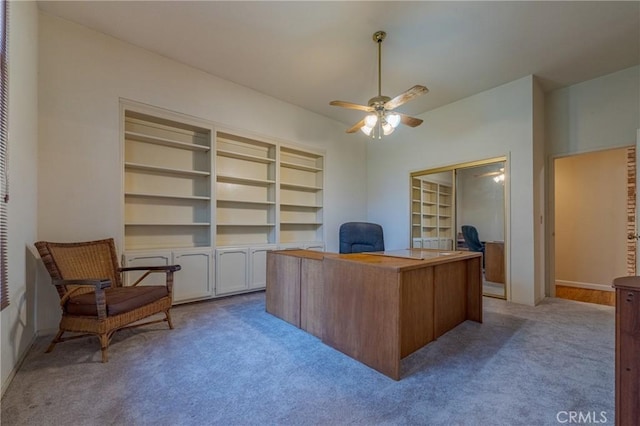 carpeted office featuring built in features, ceiling fan, and baseboards
