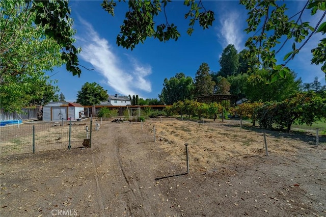 view of yard with a storage shed and a pergola