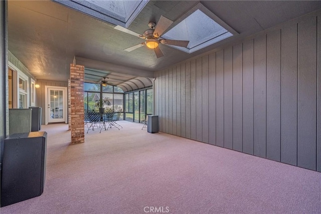 unfurnished sunroom featuring a skylight