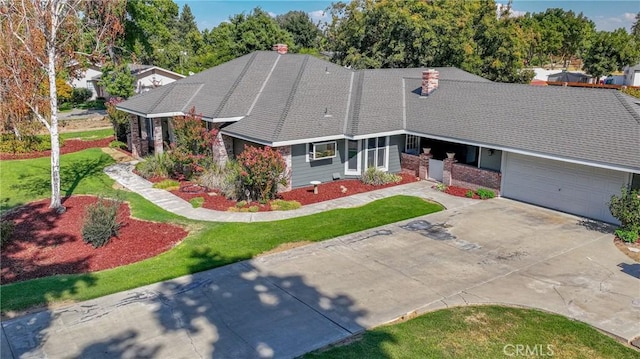 view of front facade with a garage and a front lawn