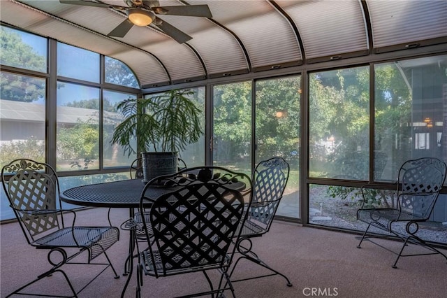 sunroom / solarium featuring lofted ceiling and ceiling fan