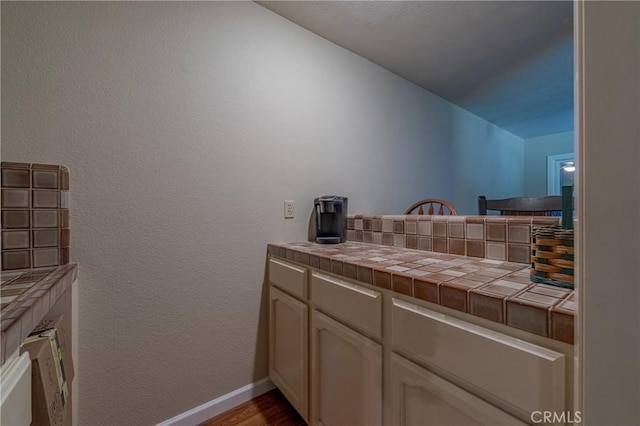 bathroom featuring baseboards and wood finished floors