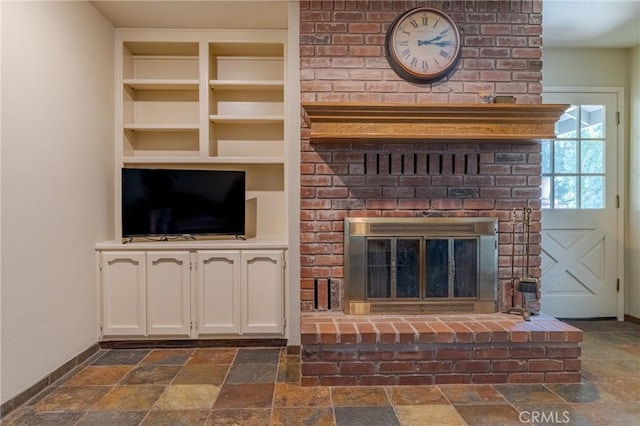 unfurnished living room with built in features and a fireplace