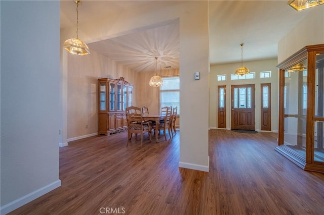 entrance foyer featuring plenty of natural light, dark hardwood / wood-style floors, and a chandelier