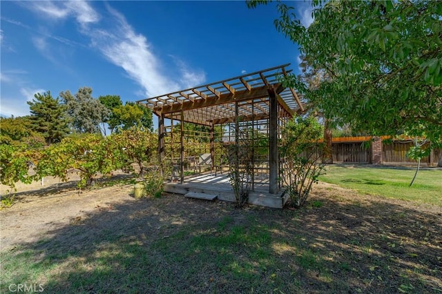 view of yard with fence, a wooden deck, and a pergola
