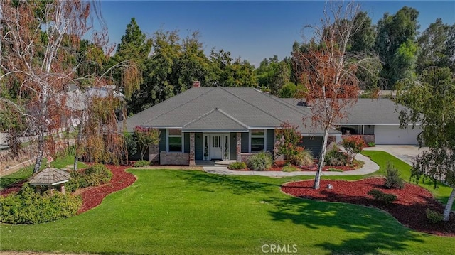 view of front of house with a front yard, a garage, and concrete driveway