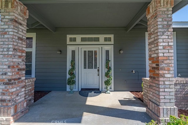 doorway to property with a porch