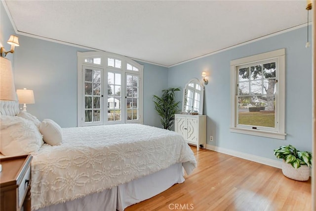 bedroom with crown molding and hardwood / wood-style floors