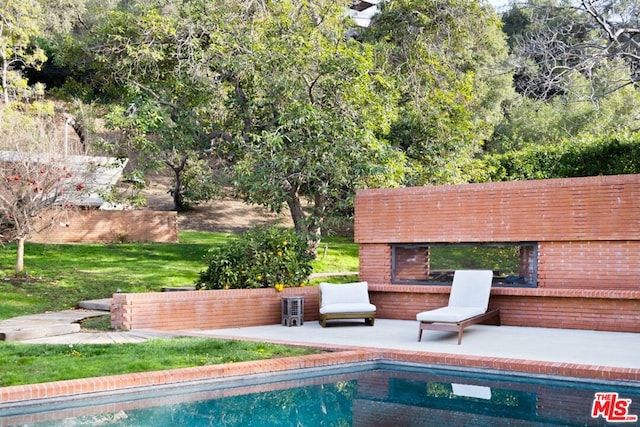 view of swimming pool with a yard and a patio