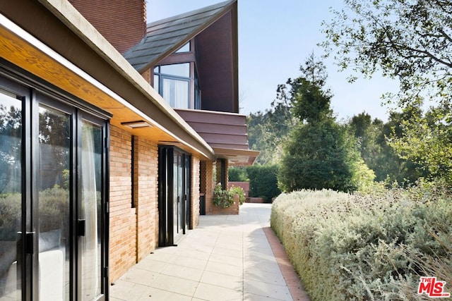 view of property exterior with a patio area