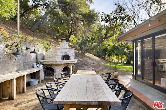 view of patio with an outdoor stone fireplace