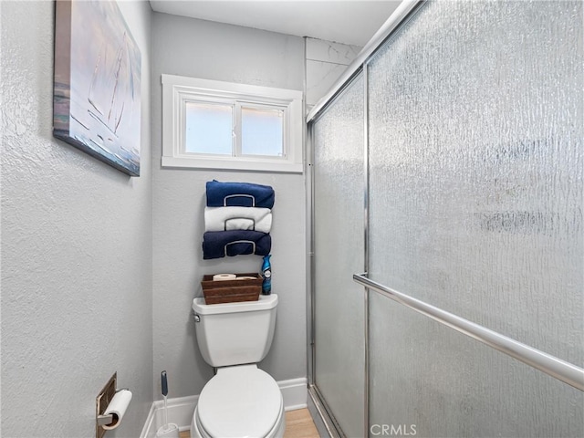 bathroom featuring toilet and walk in shower