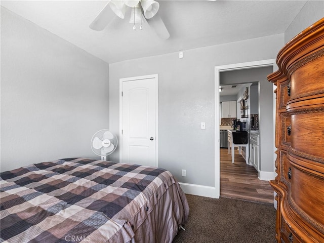 bedroom with dark colored carpet and ceiling fan