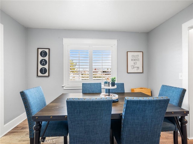 dining space with hardwood / wood-style floors