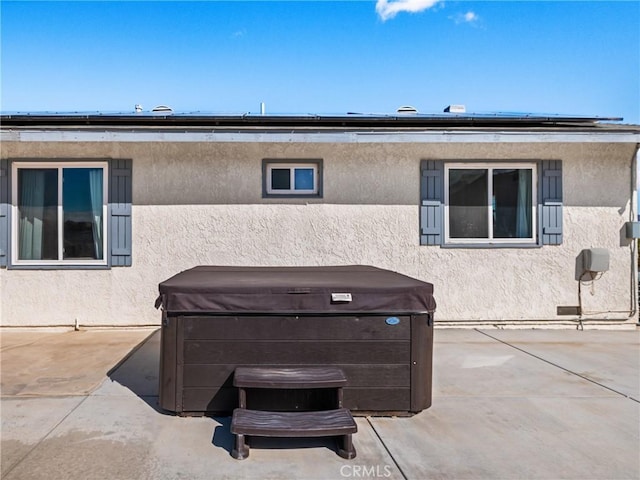 exterior space featuring a hot tub and a patio area