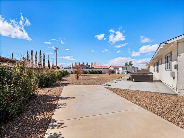 view of yard with a hot tub and a patio