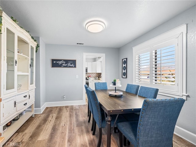 dining area with hardwood / wood-style flooring