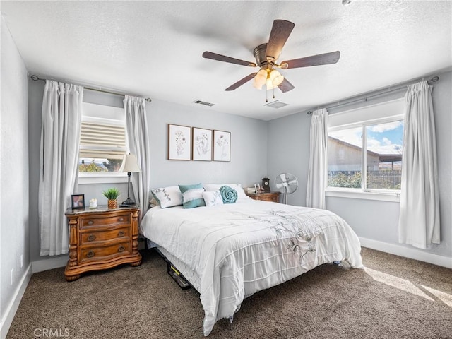 bedroom featuring ceiling fan, carpet flooring, and a textured ceiling