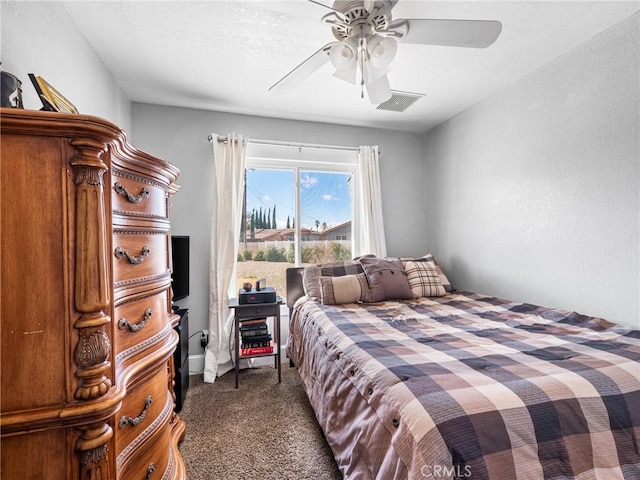 bedroom featuring ceiling fan and dark colored carpet