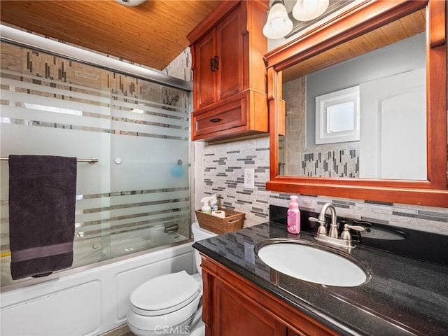 full bathroom with vanity, toilet, shower / bath combination with glass door, and decorative backsplash