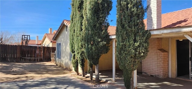 view of side of home featuring a patio area