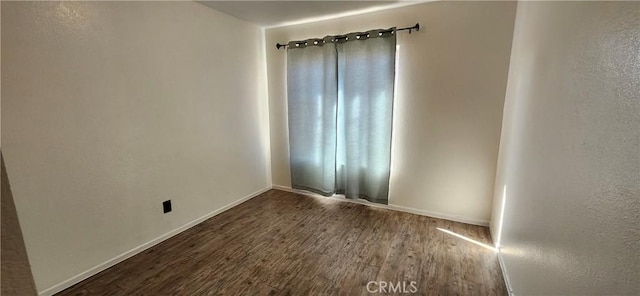 empty room with dark wood-type flooring